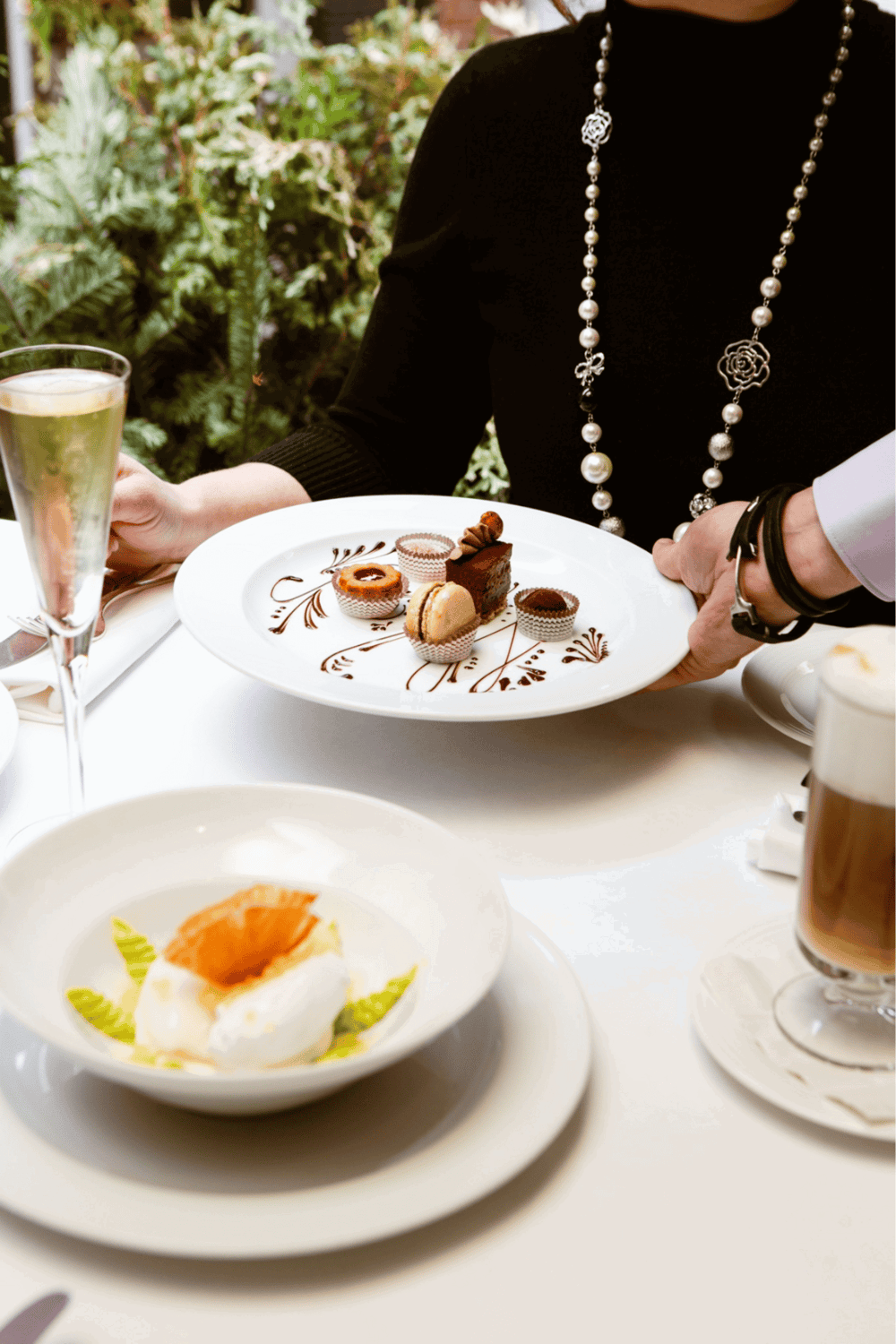 Elegant dessert presentation at upscale restaurant with gourmet sweets and fine dining ambiance.