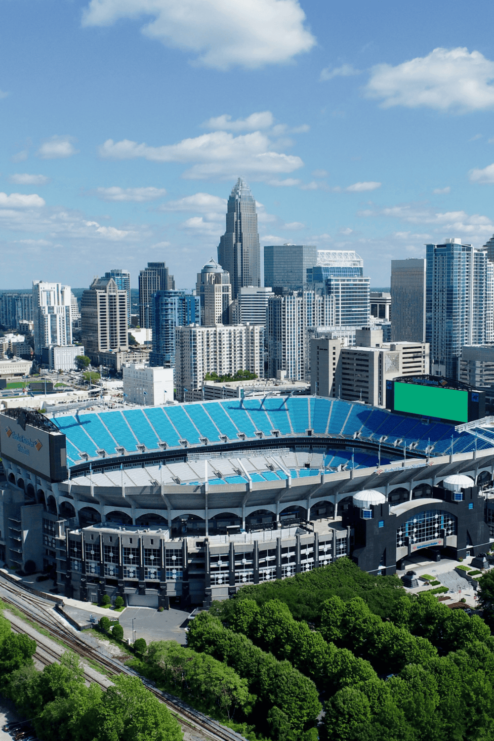 Inverted stadium with city skyline, modern buildings and blue sky.