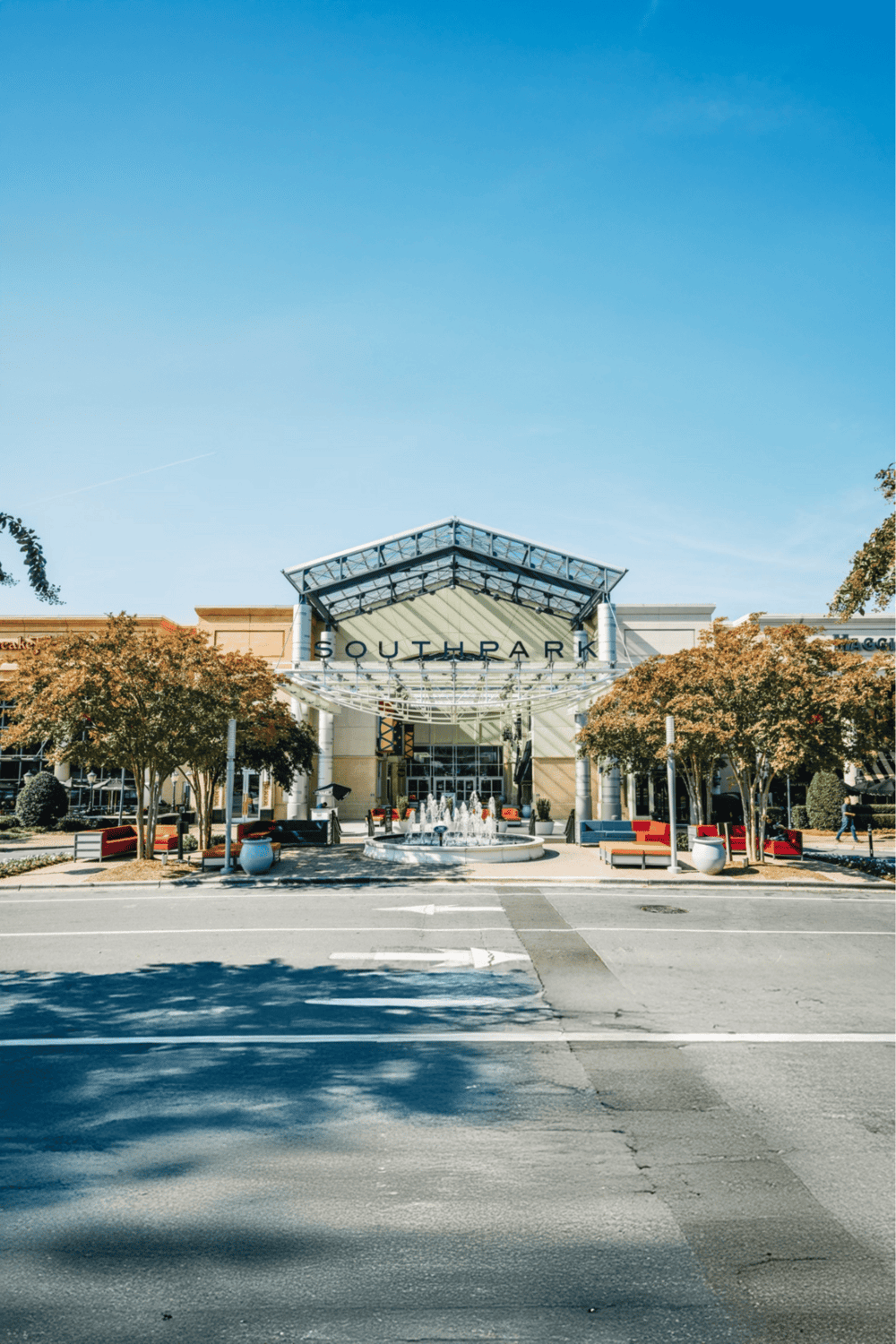 Bright shopping mall entrance with SouthPark sign, trees, and fountain in the foreground.