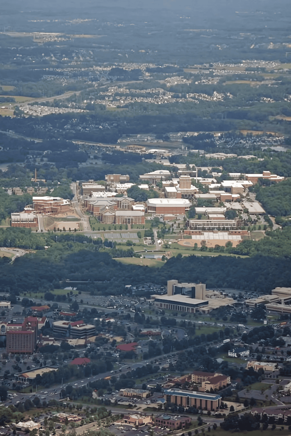 Aerial view of Quest for Directions campus with university buildings and surrounding cityscape.