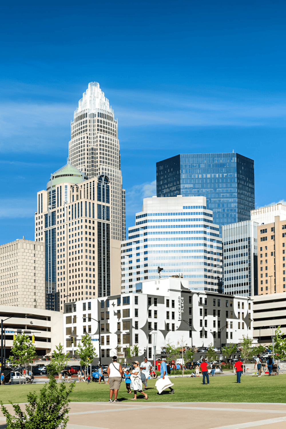 Modern downtown skyscrapers in Charlotte, North Carolina with people enjoying a park.