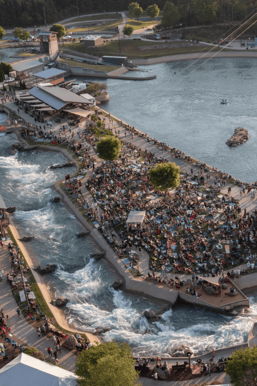 1. Aerial view of a lively waterfront with people, water attractions, and scenic park areas.