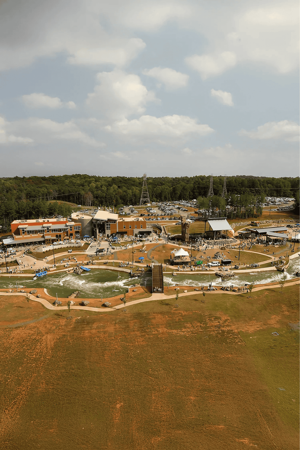 Aerial view of Quest for Directions amusement park with rides, water features, and visitors enjoying the outdoor attractions.