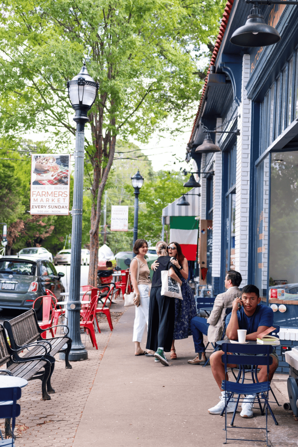 1. Outdoor street scene with people enjoying a sunny day in a lively neighborhood.
