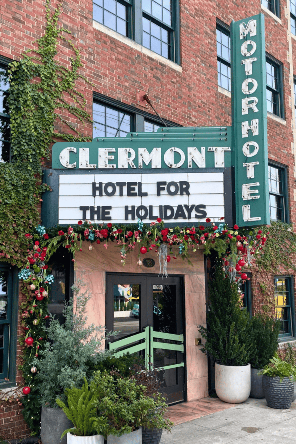 Charming boutique hotel in downtown Claremont with holiday-themed decorations and vibrant greenery.