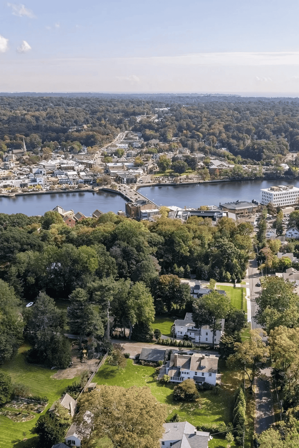 Aerial view of QuestForDirections landscape showcasing scenic town, lake, and lush greenery for navigation and Lost Key concepts.