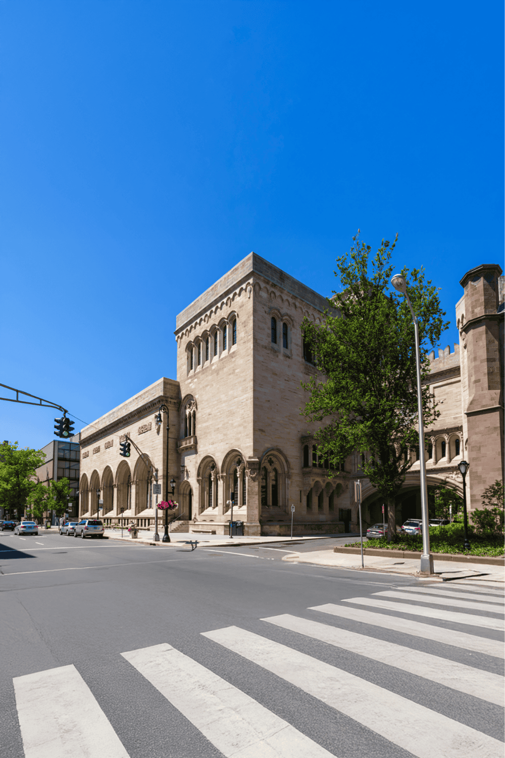 Historic courthouse on city street with blue sky, perfect for legal, government, and city travel keywords.