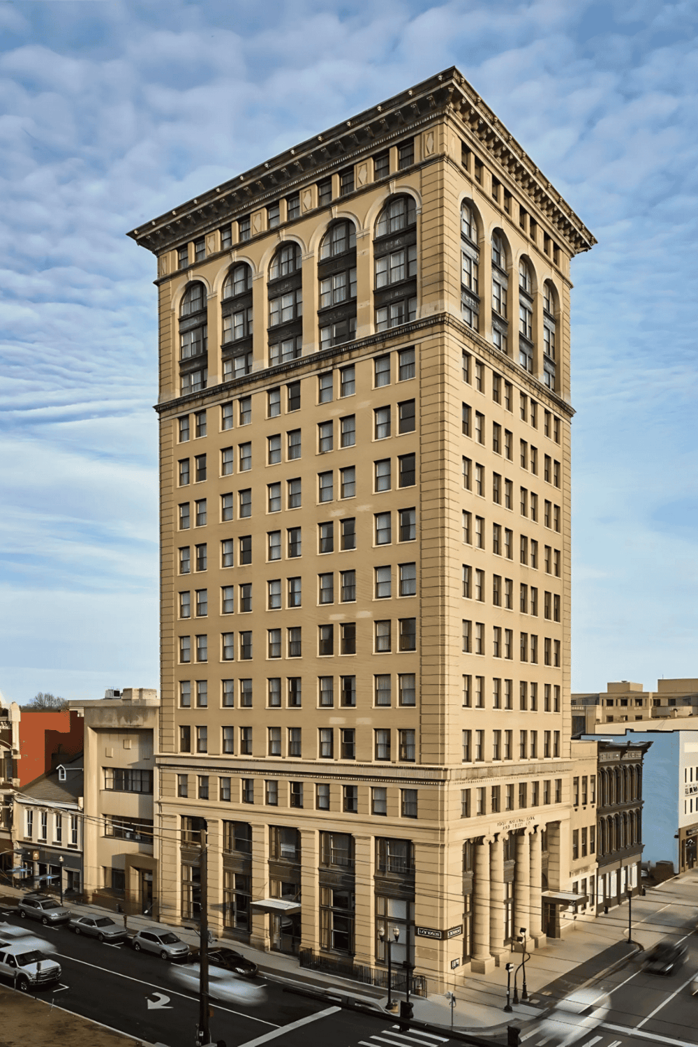 Historic downtown building with classic architecture and large windows in vibrant urban setting.