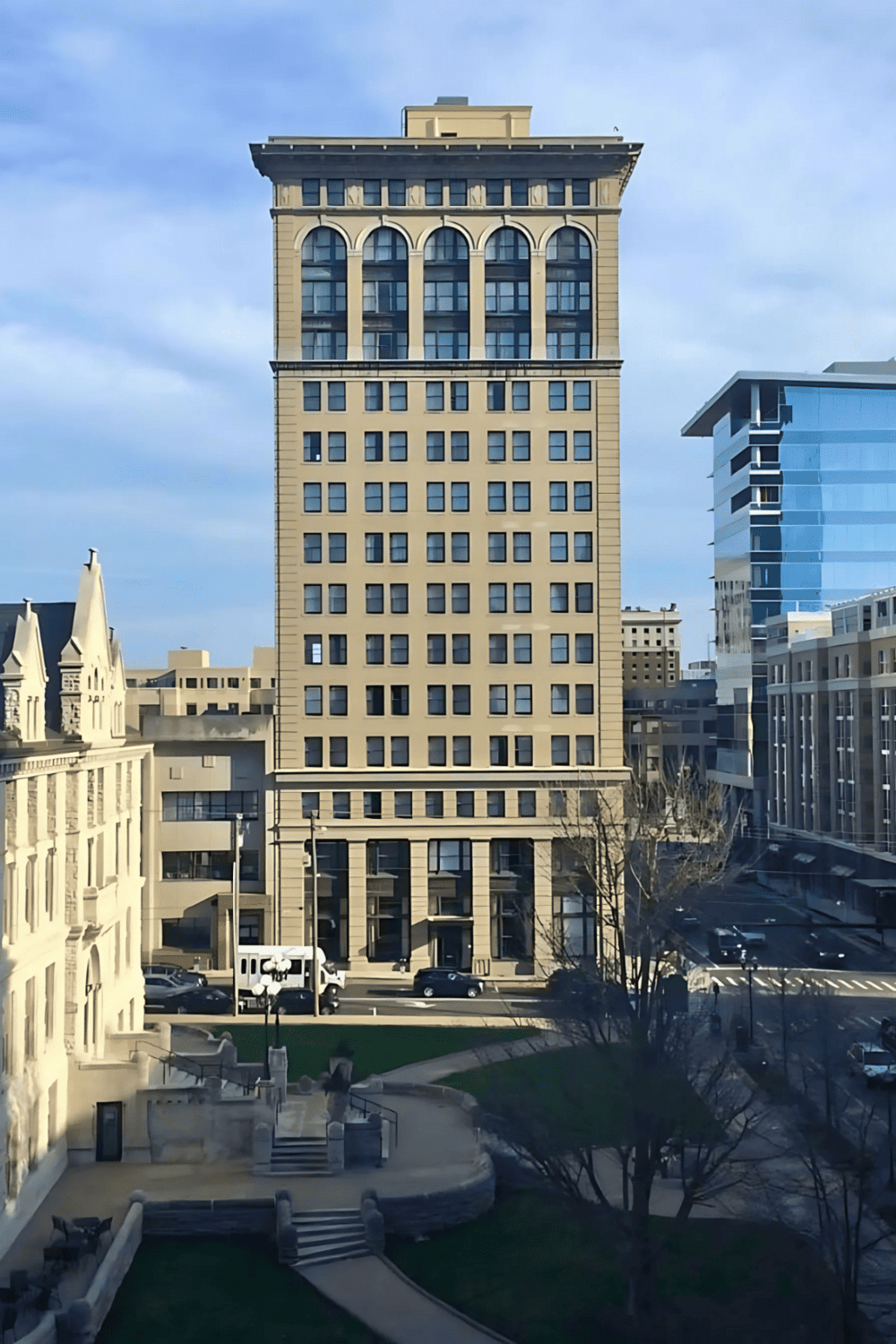 Modern downtown office building with glass windows and architectural details.