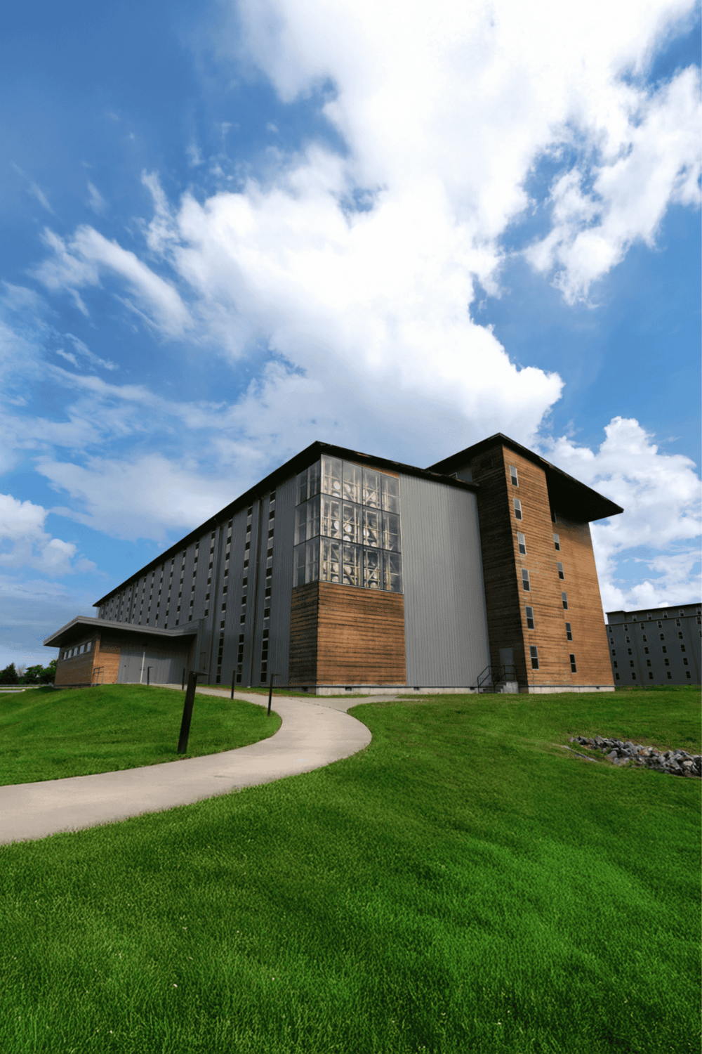 Modern college dormitory building on a sunny day with a blue sky background.