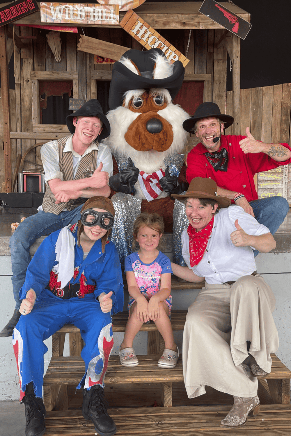 Happy cowboy group with mascot at Quest for Directions event.