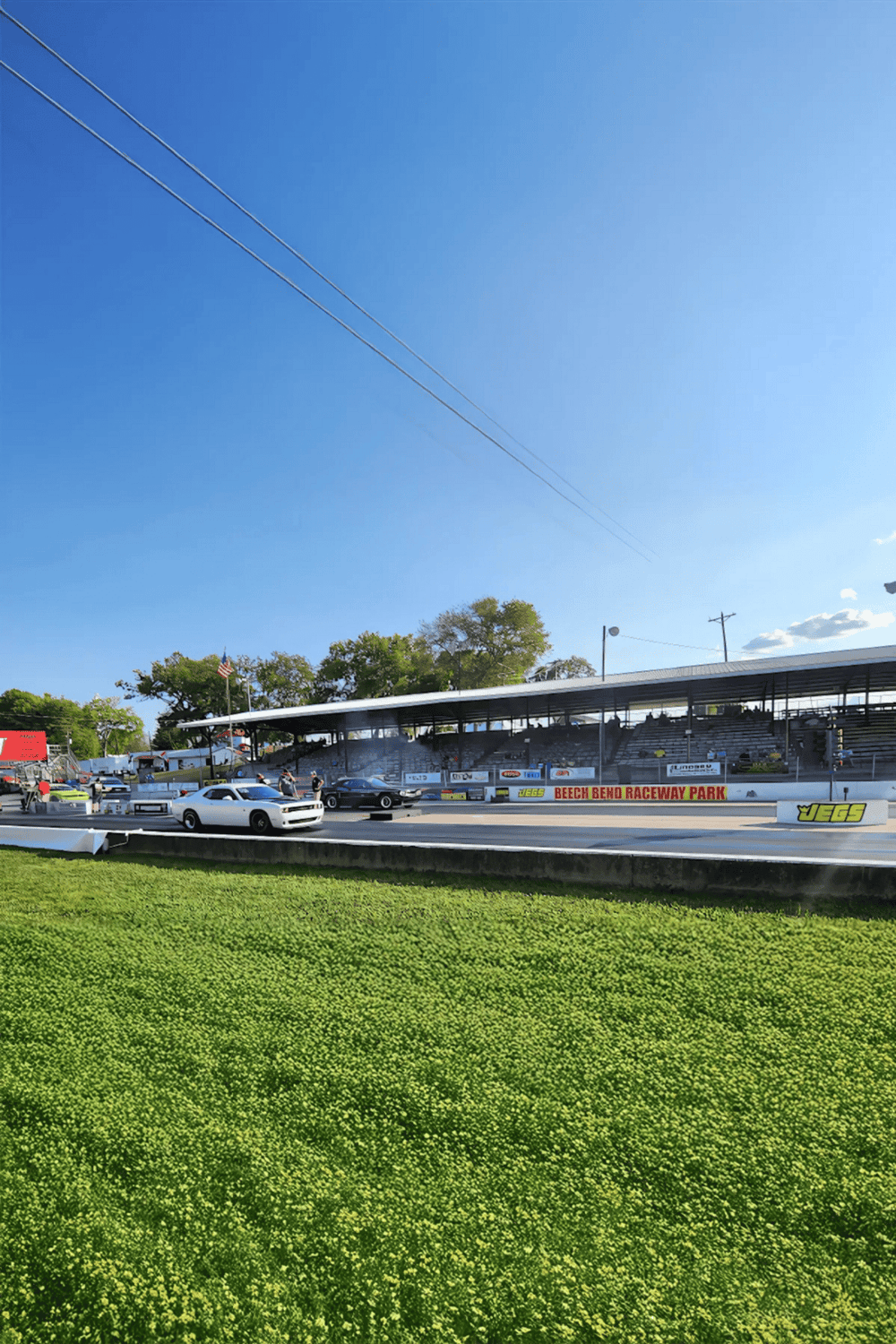 Raceway at Beech Bend Raceway Park during daytime with cars ready for drag racing.