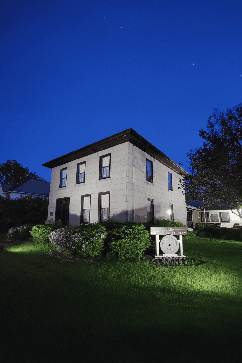 1. Night view of Berea Historical Society building under a starry sky in Ohio.