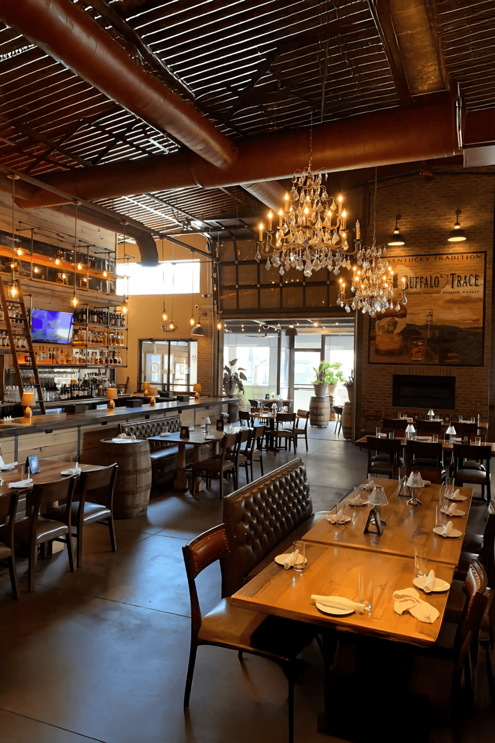 Chic rustic restaurant interior with wooden furniture, chandeliers, and modern decor, perfect for dining and social gatherings.