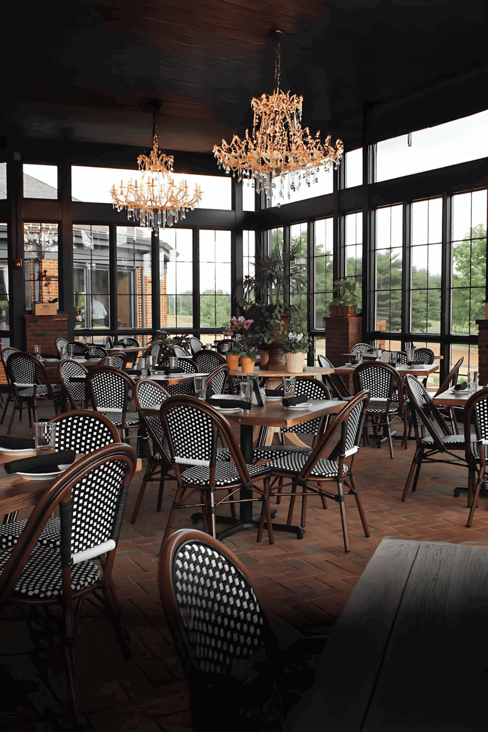 Elegant restaurant interior with chandeliers and large windows, perfect for dining experiences.