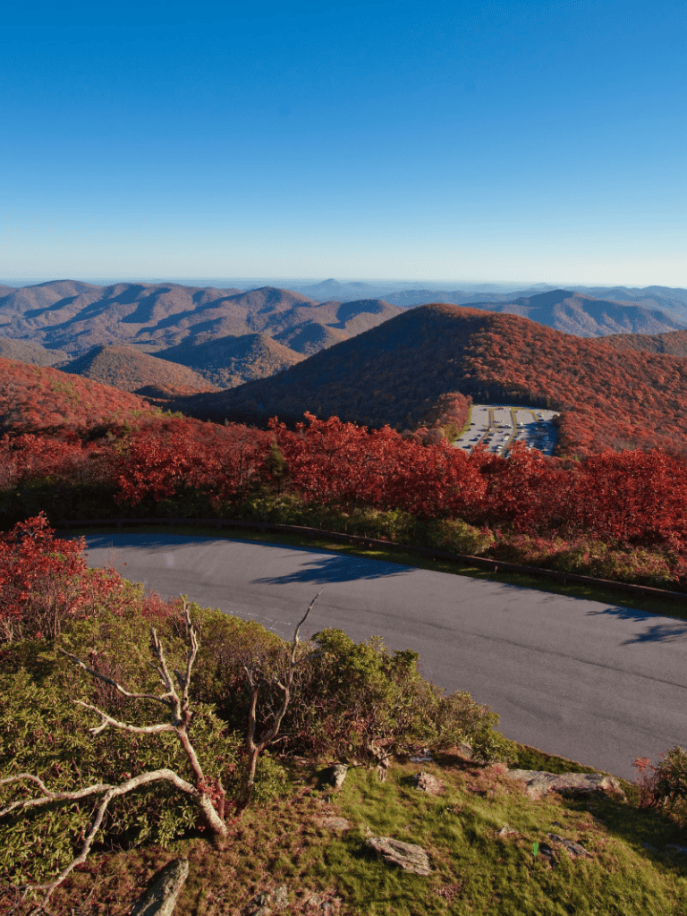 Scenic mountain landscape with colorful fall foliage and winding road in the Appalachian Mountains.