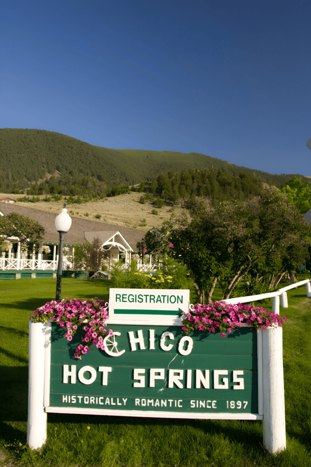 Hot Springs registration sign in Chico, California, charming welcoming entrance near scenic mountains.