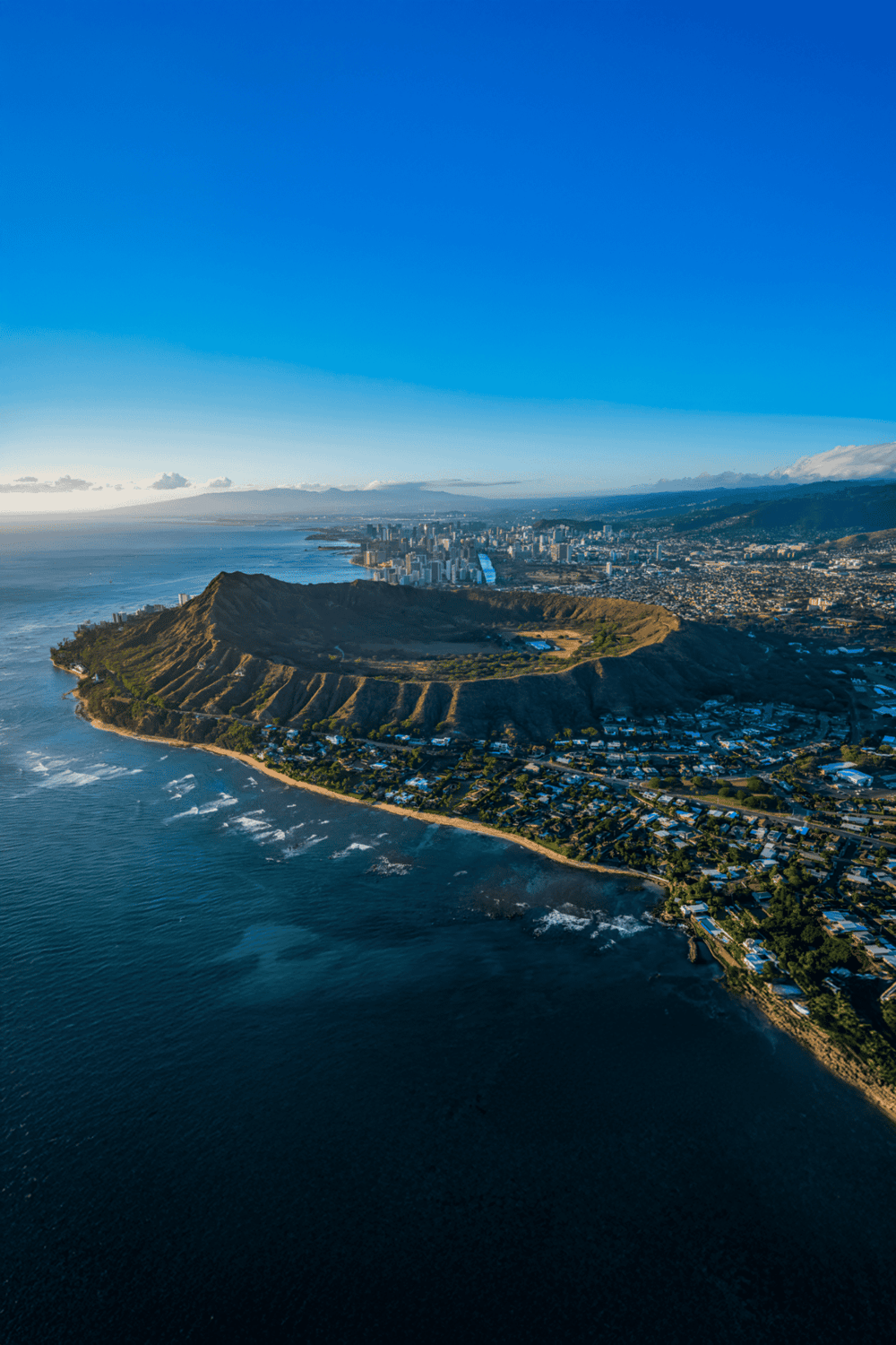 Aerial view of Diamond Head crater and Honolulu skyline, Hawaii, scenic island destination with outdoor adventure.
