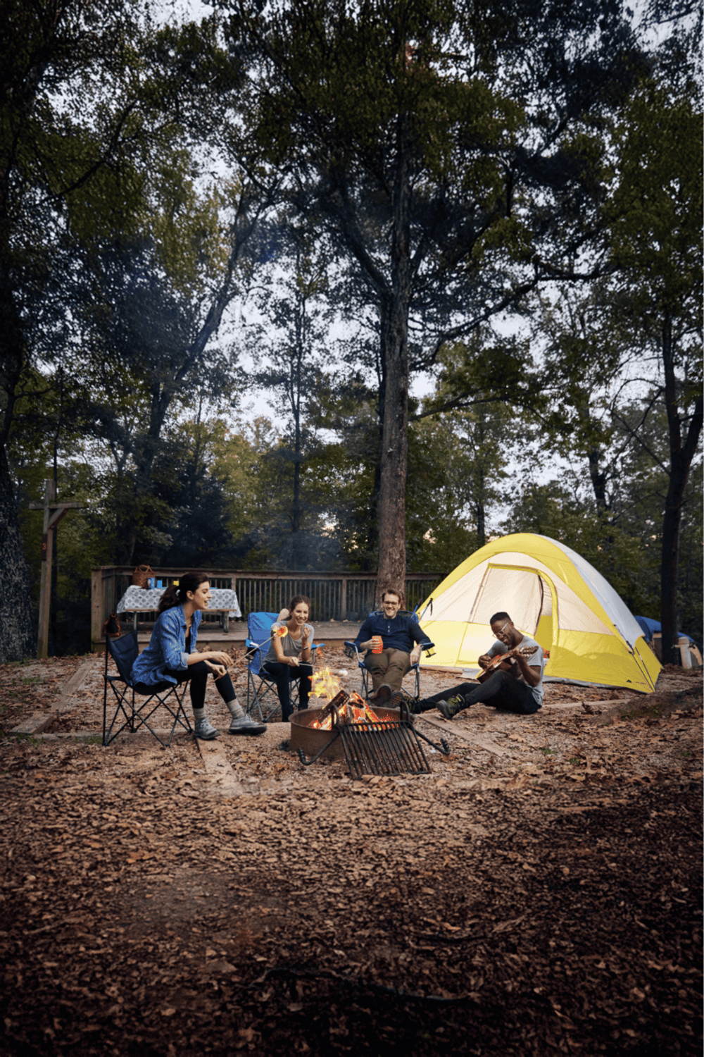 Relaxing camping trip with friends at a forest campsite, enjoying a campfire and guitars.