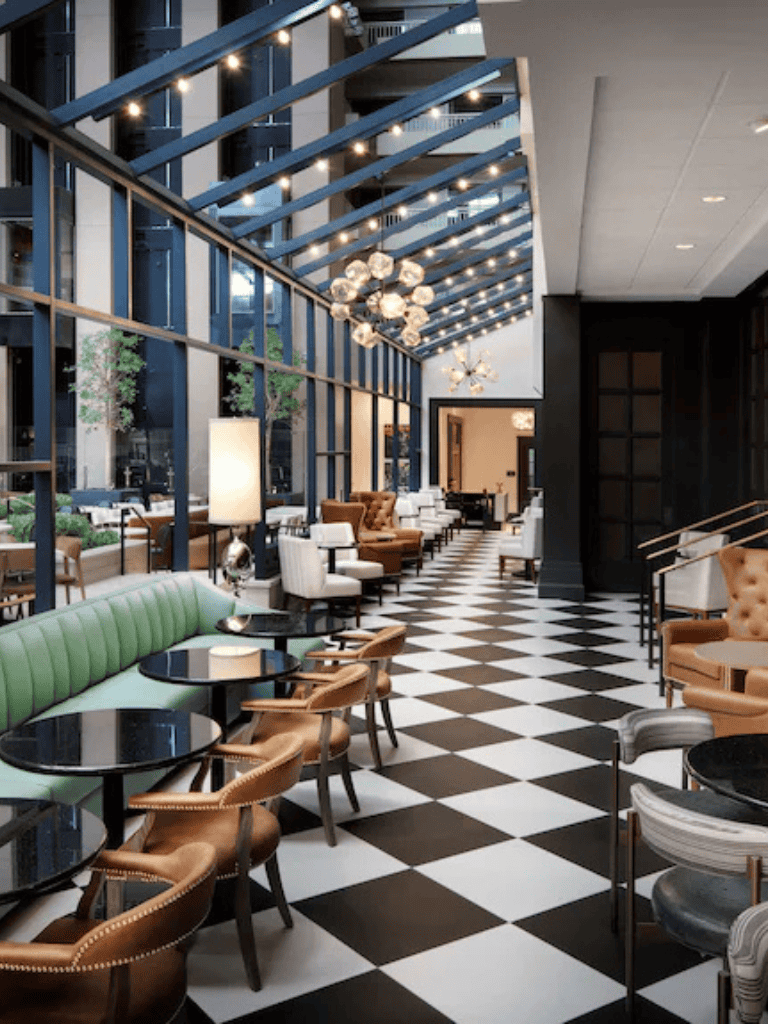 Luxurious hotel lobby with modern decor, high ceilings, stylish seating, and ambient lighting for guest comfort.