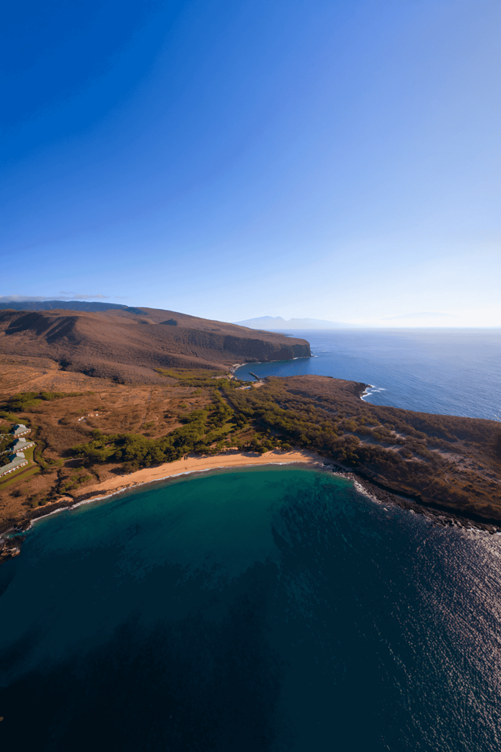 Scenic ocean coastline with cliffs and sandy beach, top travel destination for adventure and relaxation.