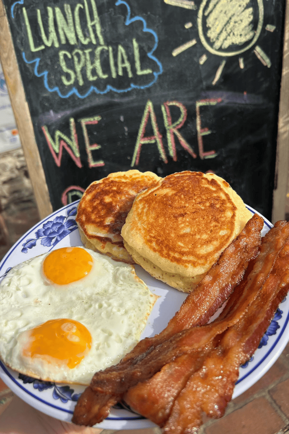 Large breakfast plate with eggs, bacon, and fried bread, perfect for a hearty brunch.