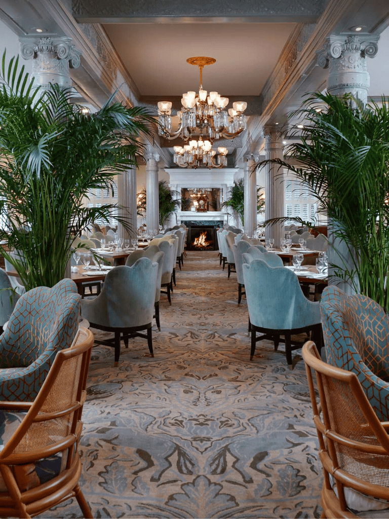 Elegant dining room with luxurious decor and chandeliers, perfect for upscale restaurants or event venues.