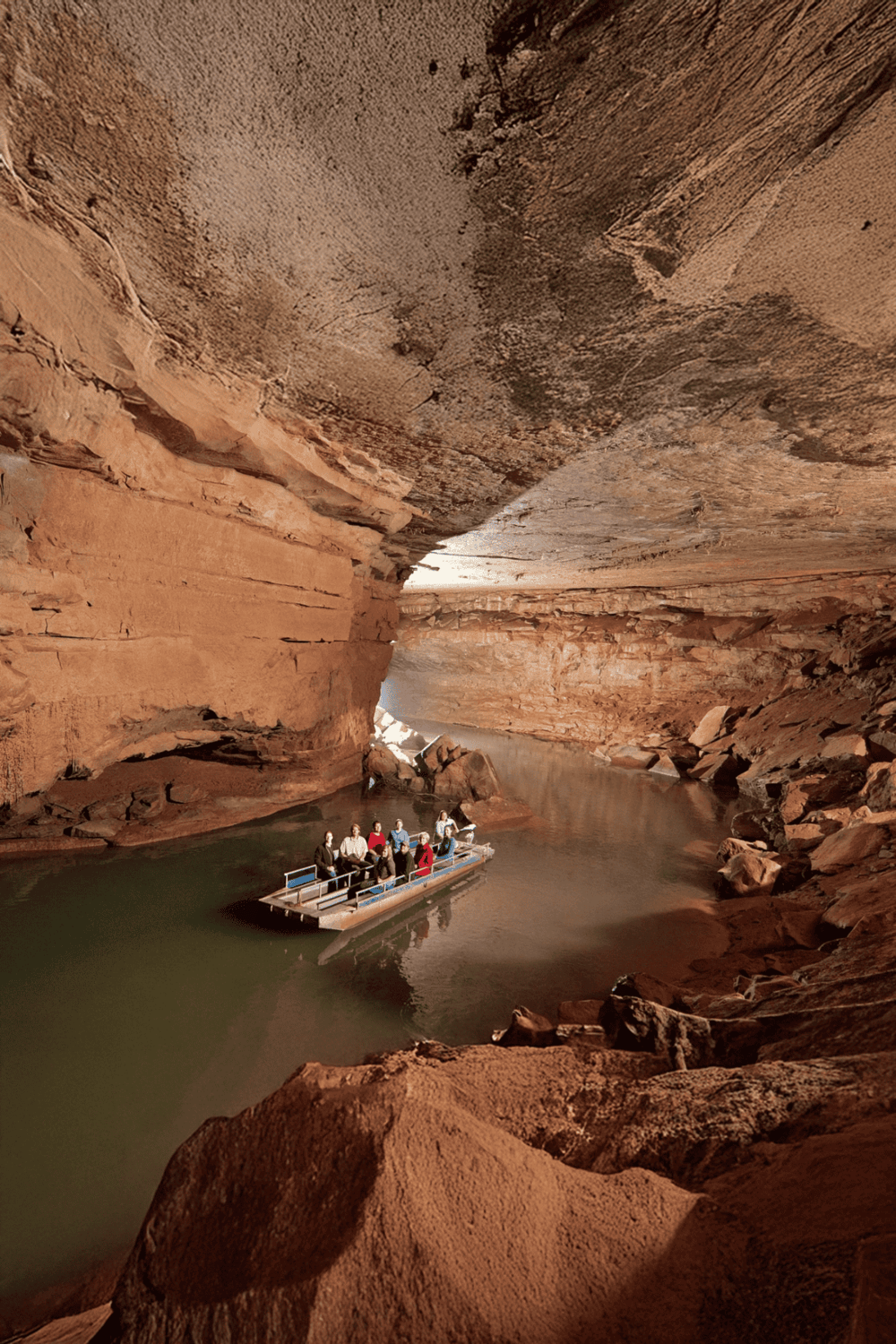 Steamboat inside Red Canyon, scenic boat tour through towering red rock walls, adventure travel, Arizona canyon exploration.
