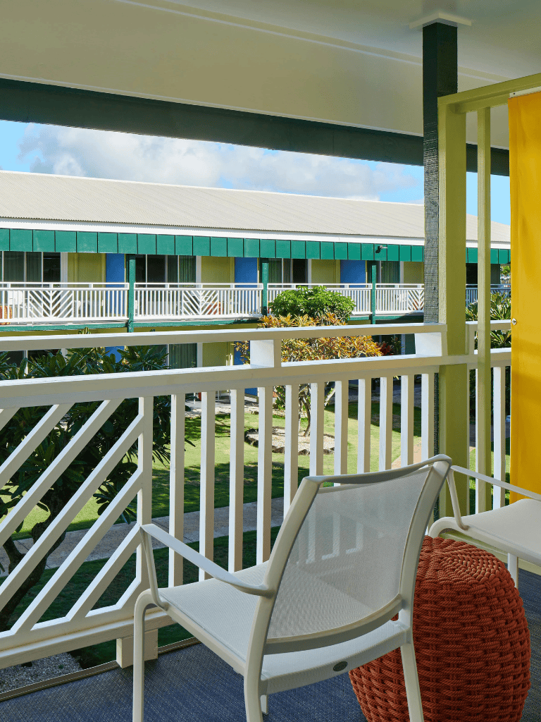 Relaxing balcony view of tropical resort with garden and modern accommodations.