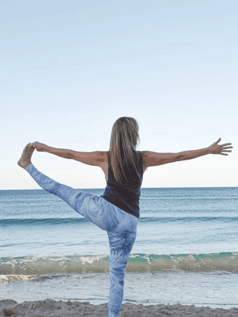 Yoga on the beach, woman performing yoga pose, outdoor wellness, coastal relaxation, fitness and mindfulness.