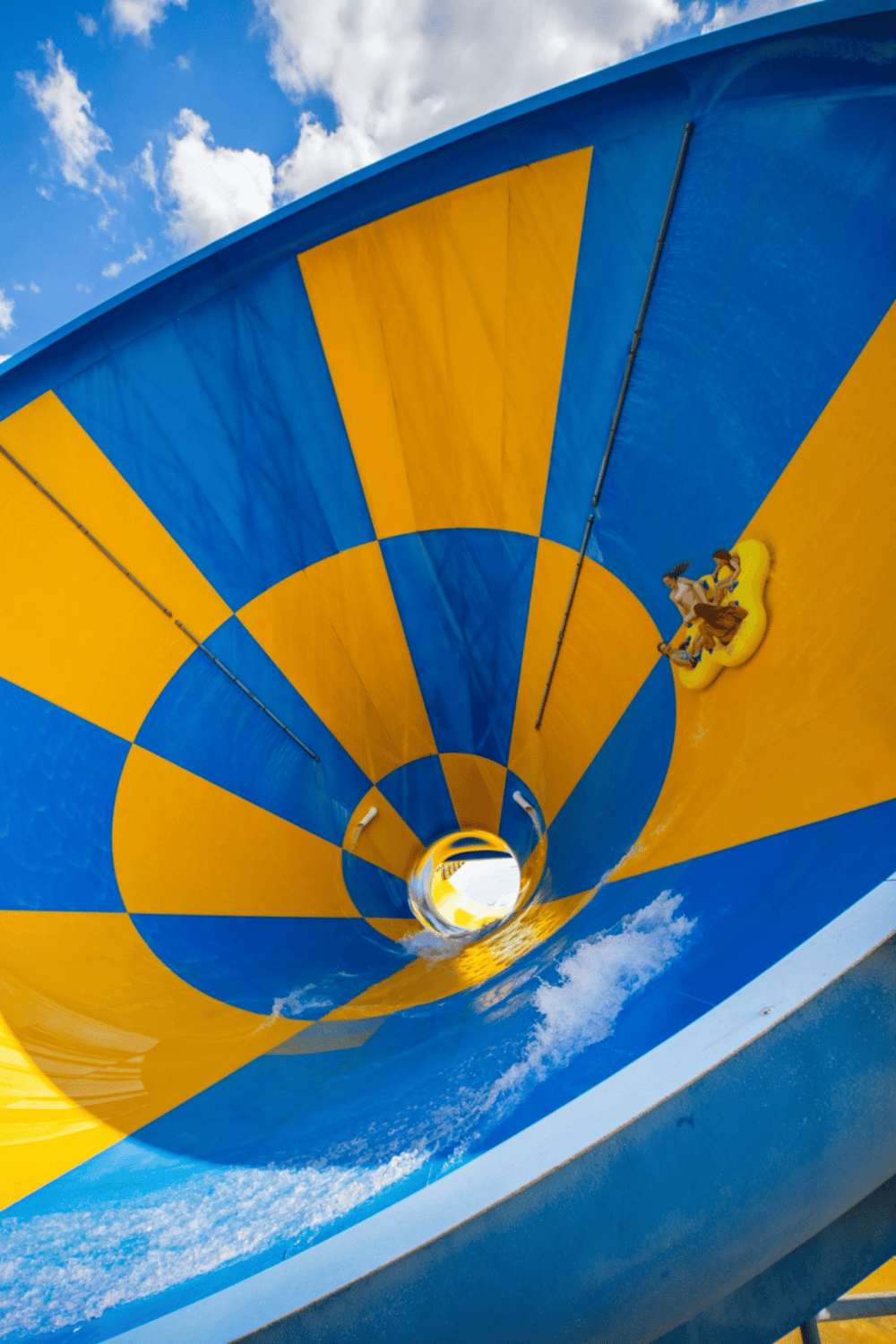 Thrilling water slide with blue and yellow checkered pattern, perfect for adventure and fun at QuestForDirections.