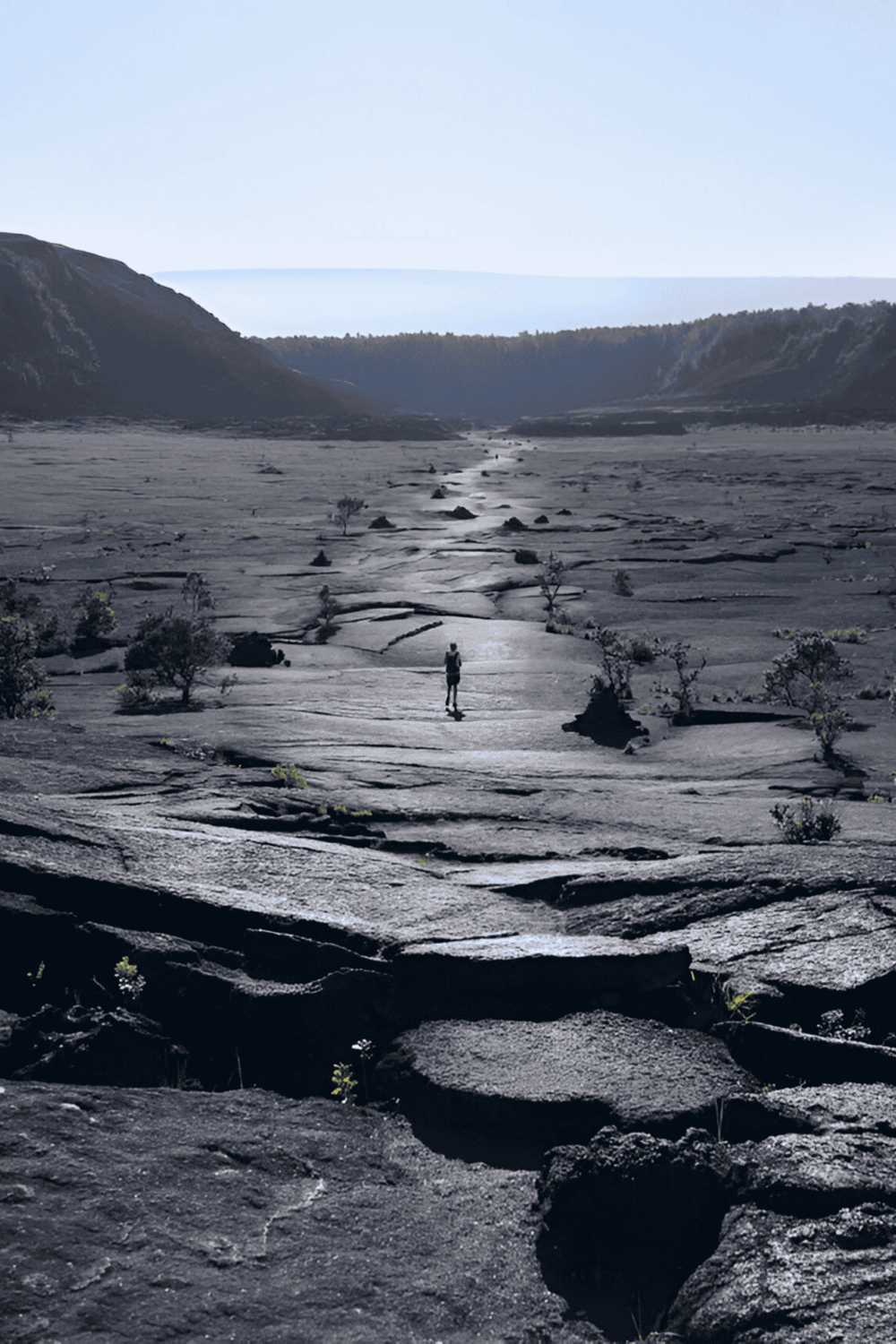Lovely volcanic landscape with a lone hiker discovering the unique terrain. Perfect for outdoor adventure and exploration.