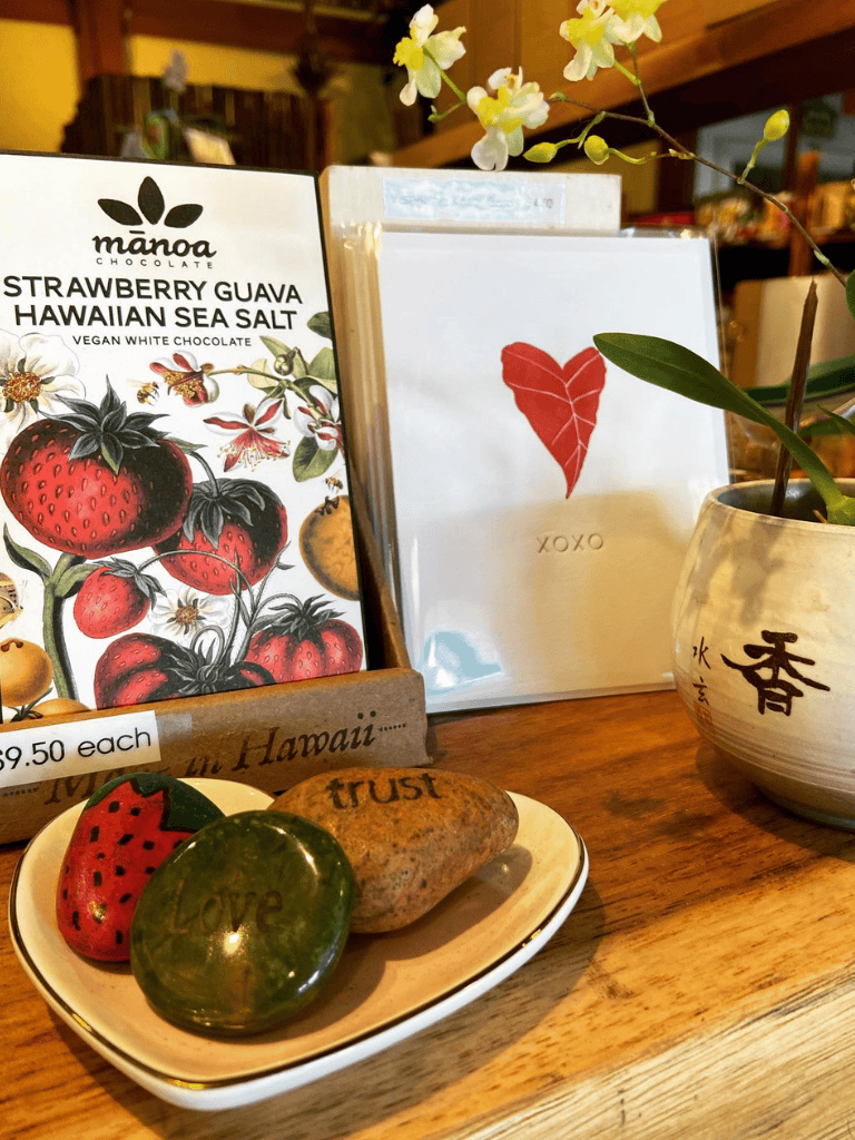 Strawberry Guava Hawaiian Sea Salt vegan white chocolate, decorative stones with words love, trust, and hope, plant in a ceramic pot.