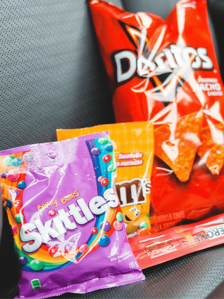 Fun snacks like Doritos, Skittles, and teddy graham crackers for road trips and travel | SEO image tags and description.