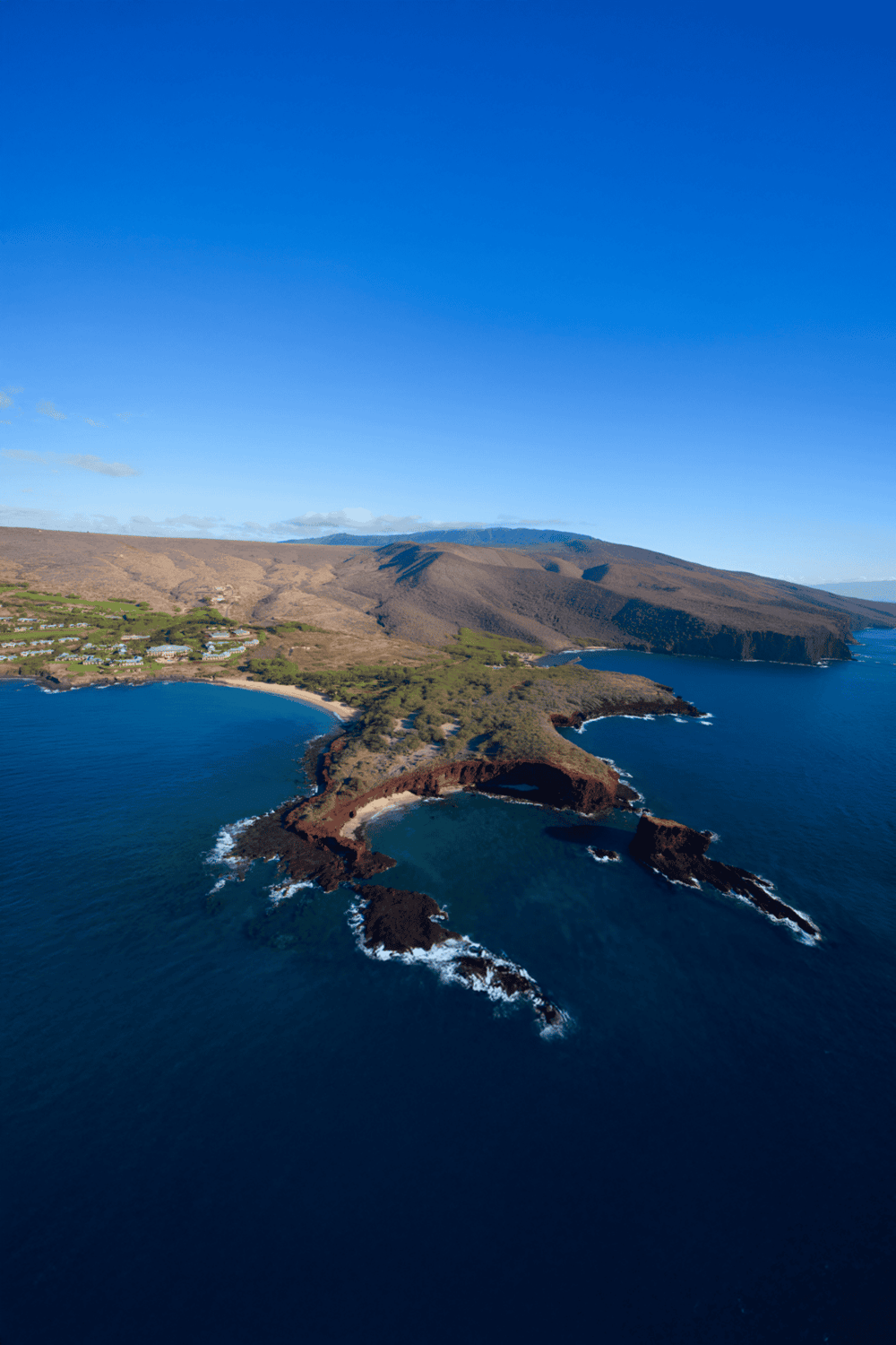 Cliffs and coastline of Quest for Directions island overlooking the ocean and rugged landscape.