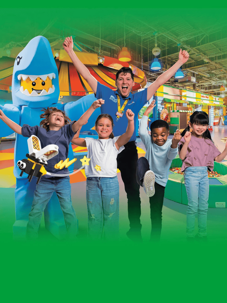 Fun family entertainment at Quest for Directions indoor amusement park with kids and staff celebrating joyfully.