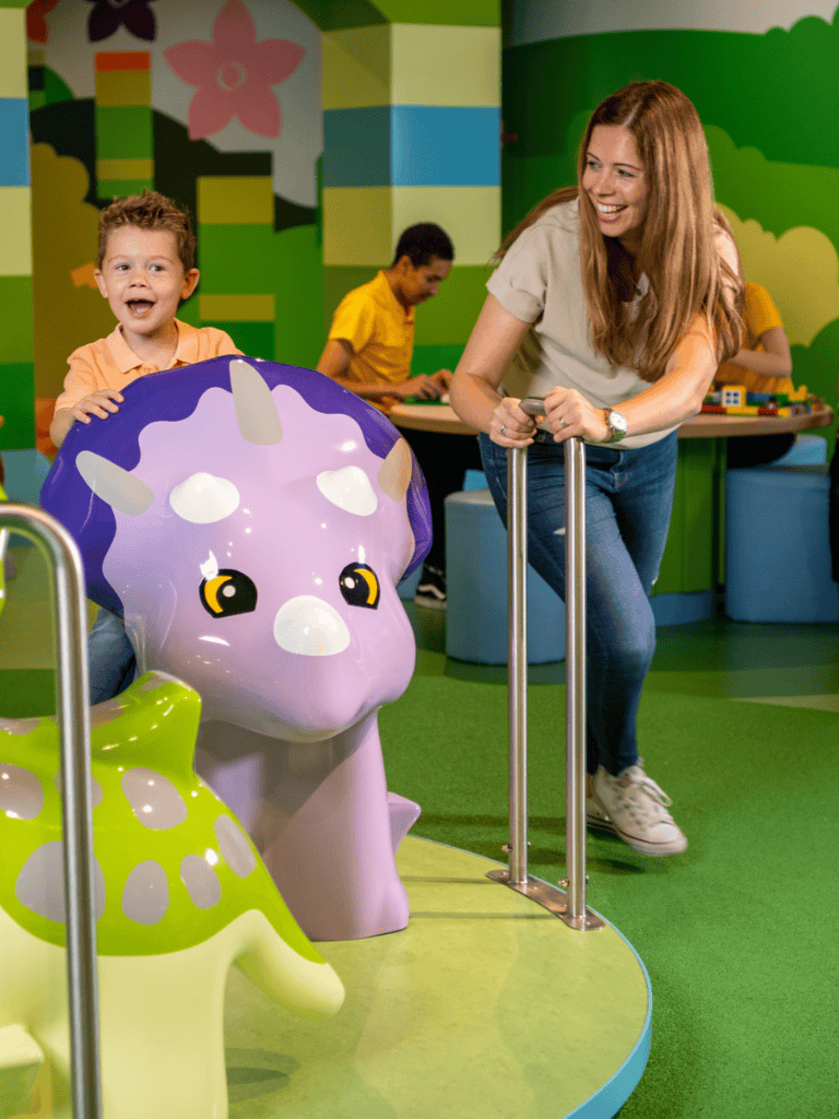 Colorful indoor children's play area at QuestForDirections with playful animal-themed ride-ons and happy kids.