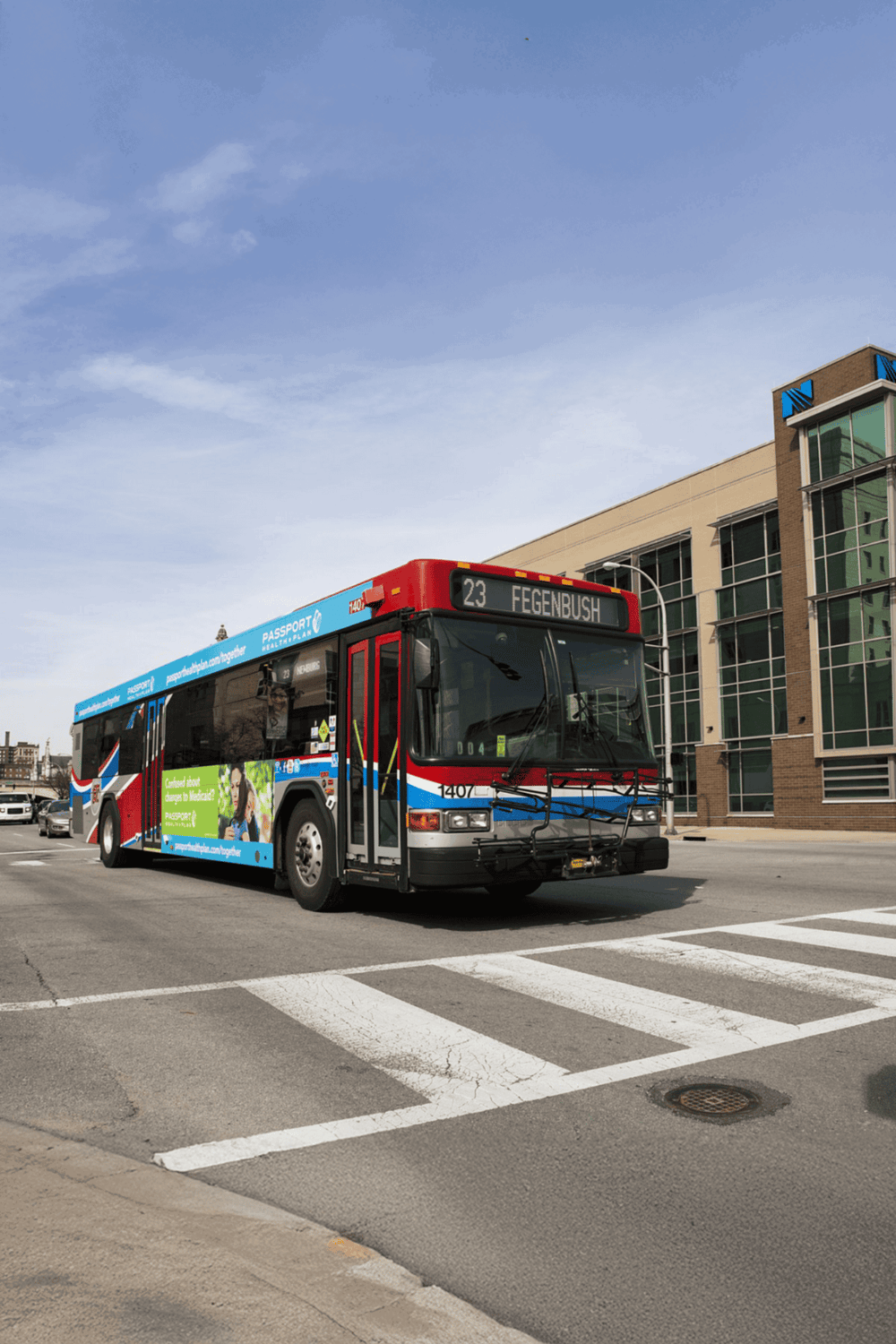 Public transit bus on city street with Quest for Directions branding, promoting navigation aid services.