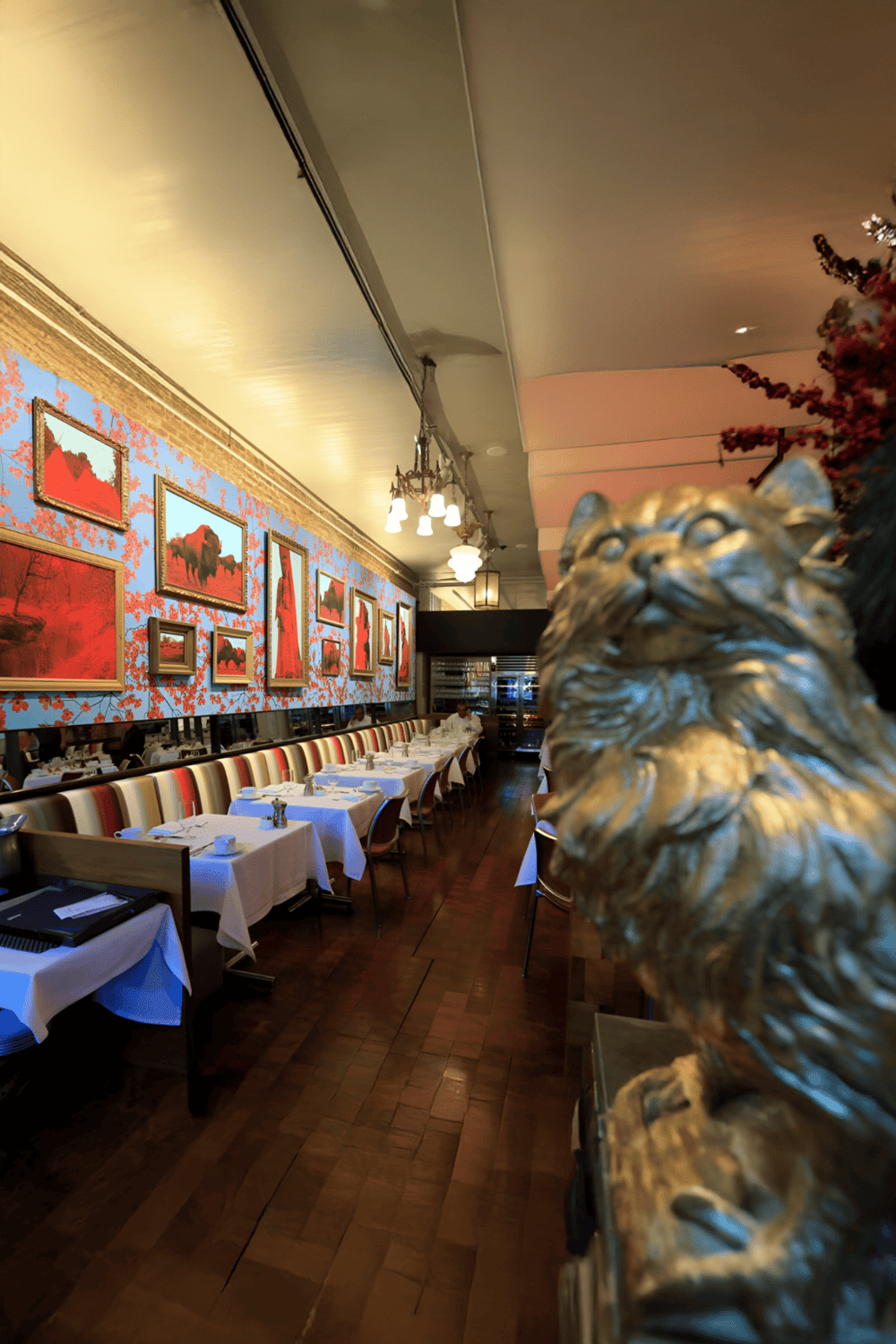 Elegant restaurant interior with artwork and lion statue for fine dining | QuestForDirections.