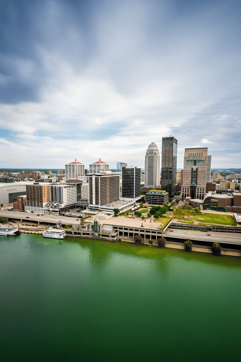Downtown city skyline with high-rise buildings and waterfront view, promoting urban navigation and directions.