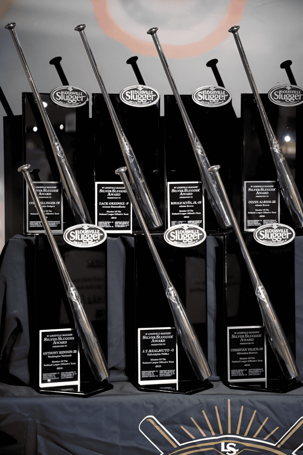 Celebration of Louisville Slugger baseball bat awards with custom plaques, showcasing craftsmanship and sports excellence.