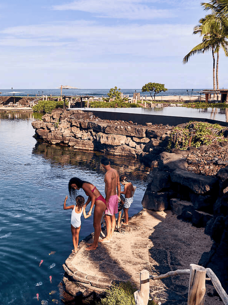 Peaceful family enjoying waterfront scenery at Quest For Directions tropical resort.