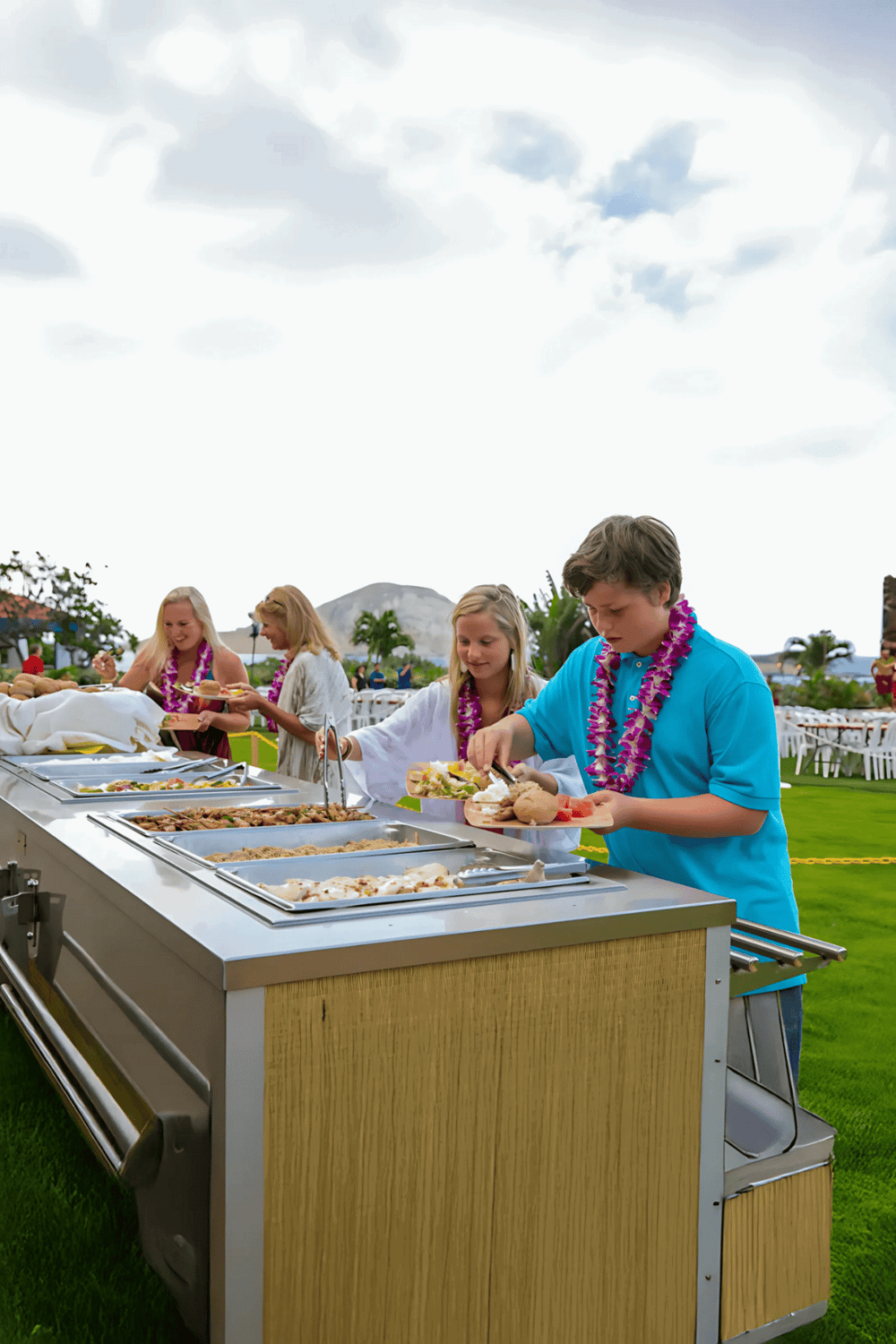 Fresh outdoor buffet at QuestForDirections event with guests enjoying food and socializing.