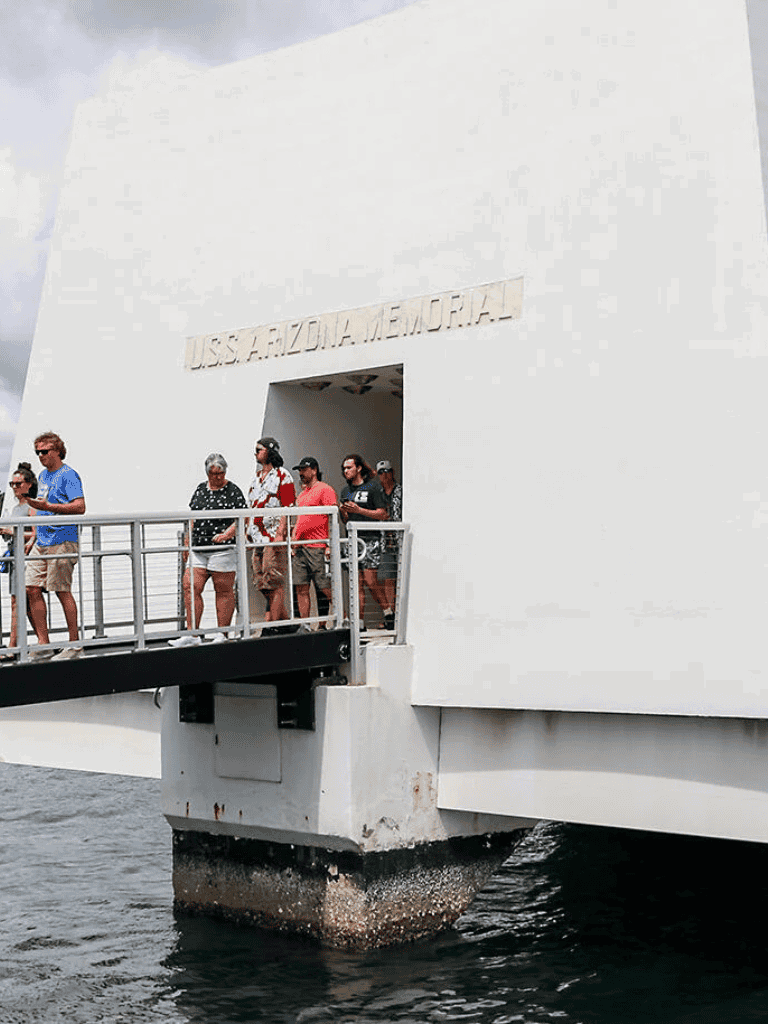 People visiting USS Arizona Memorial in Pearl Harbor, guided tour and historical site exploration.