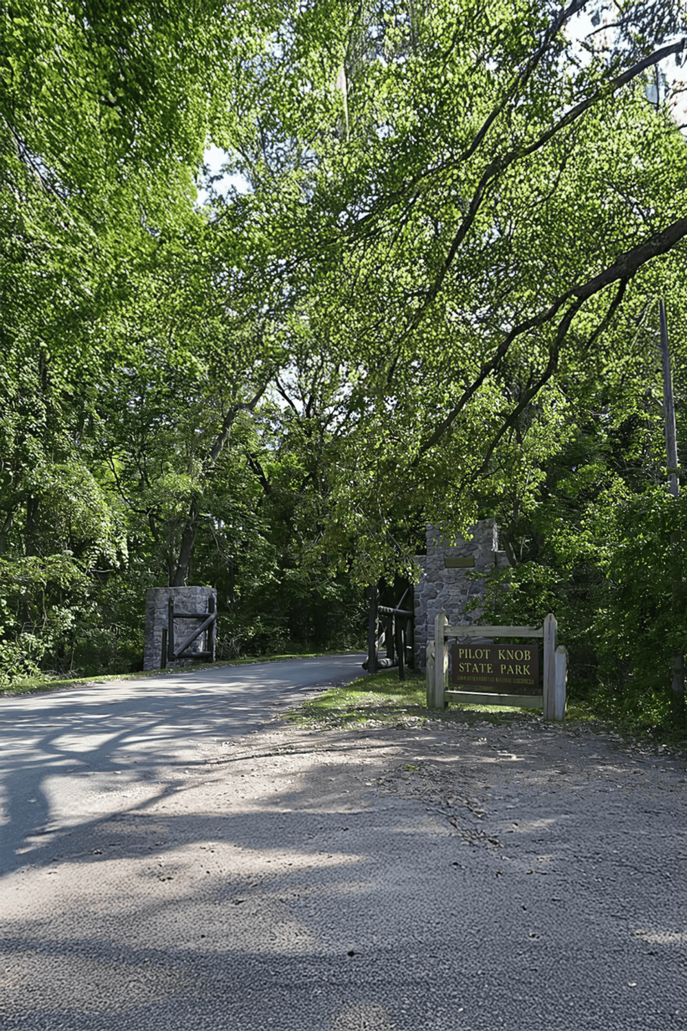 Lush green trees at Pilot Knob State Park entrance, surrounded by nature and scenic beauty.