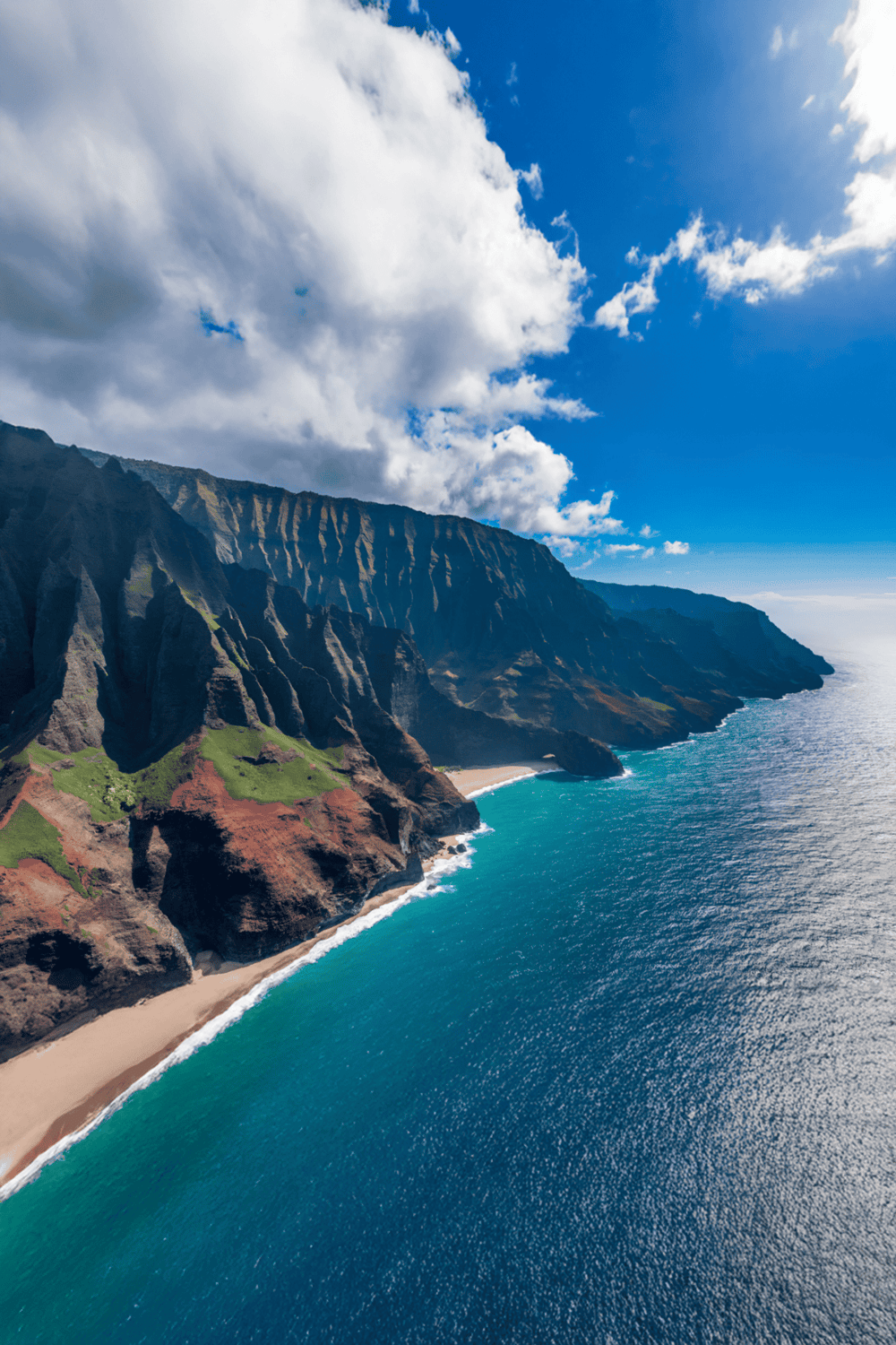 Majestic coastal cliffs and turquoise ocean at Na Pali Coast, Hawaii, famous for scenic adventure trips.