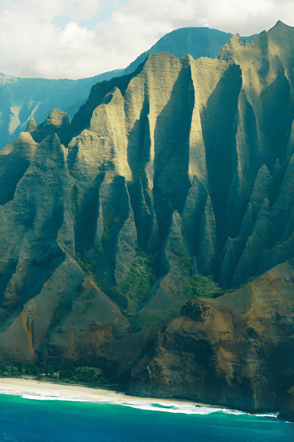 Majestic mountain landscape with lush greenery and scenic ocean view.