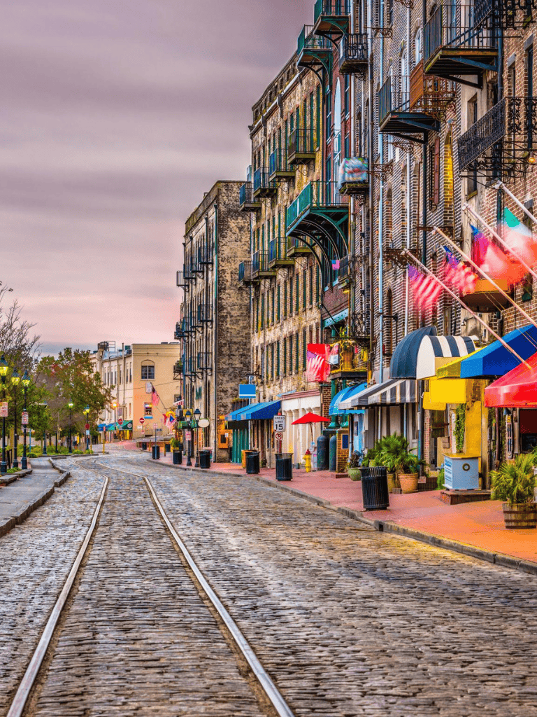 Vintage cobblestone street with colorful historic buildings and shops, perfect for exploring city history and architecture.