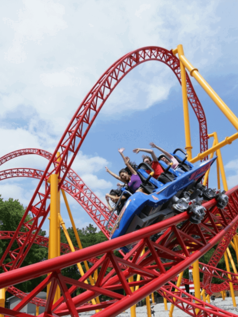 Thrilling roller coaster ride at QuestForDirections amusement park with joyful riders.
