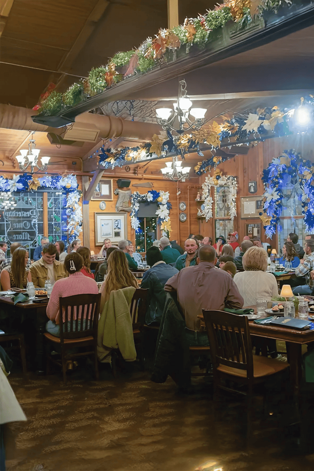 Celebratory holiday gathering with decorated interior, festive lights, and community dining atmosphere.